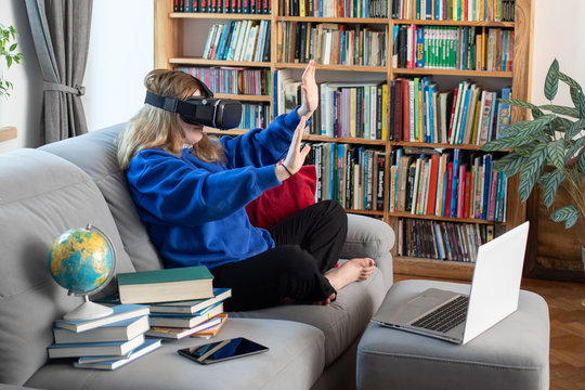 girl uses a virtual reality glasses vr mask , young girl uses virtual reality glasses online education - Powered by Adobe
