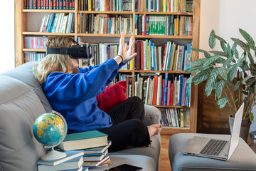 girl uses a virtual reality glasses vr mask , young girl uses virtual reality glasses online education