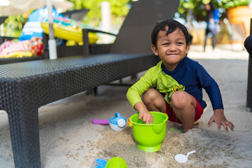 Kids playing with beach sand with they toys