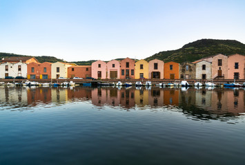 Fototapeta na wymiar The Colorful Old buildings of Bosa reflected on the Temo River, Sardinia
