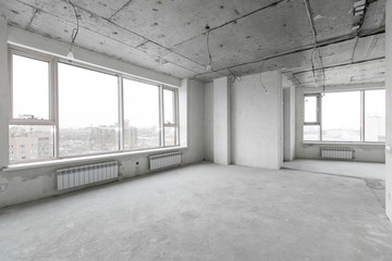 interior of a new apartment without finishing in gray tones with electrical wiring