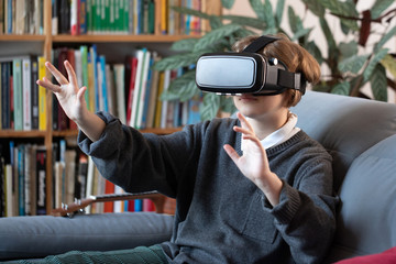 girl uses a virtual reality glasses vr mask , young girl uses virtual reality glasses online education