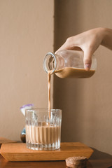 Pour latte from the bottle into the glass
