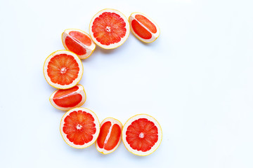 High vitamin C, Letter C made of grapefruit slices isolated on white background.