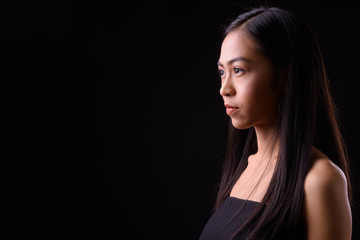 Closeup profile view of young beautiful Asian woman