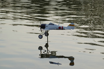 Japan Retro Fighter Plane is flying against the river.