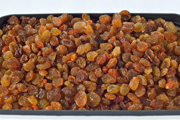 Texture of yellow and orange raisins. Dry raisins on the pile.