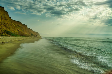 Beautiful sunset over sea with reflection in water, majestic clouds in the sky