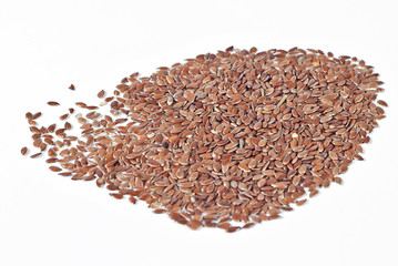 Texture of flax seeds. Many grains of flax on the pile. Flax on a white background.