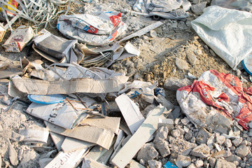 Building or construction debris or garbage left on a country road. Nature and soil pollution. Concept of preventive measures, recycle, penalties for improper disposal of waste. Transportation service.