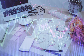 Forex market chart hologram and personal computer background. Multi exposure. Concept of investment.