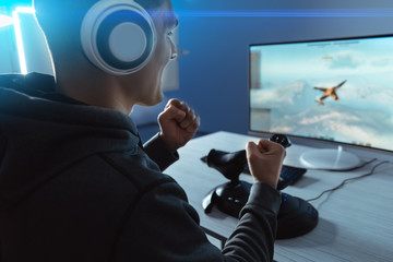 The gamer playing video game on his personal computer