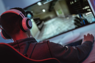 The young gamer playing online video game on his personal computer © Artem
