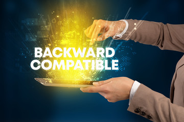 Close-up of a touchscreen with BACKWARD COMPATIBLE inscription, innovative technology concept