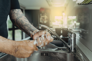 A man washing his hands with foam hand wahs for corona virus prevention, hygiene to stop spreading coronavirus.