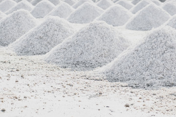 Fototapeta premium Sea salt piles in evaporation pond in Thailand