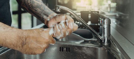 A man washing his hands with foam hand wahs for corona virus prevention, hygiene to stop spreading coronavirus.