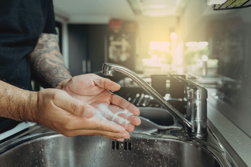 A man washing his hands with foam hand wahs for corona virus prevention, hygiene to stop spreading coronavirus.