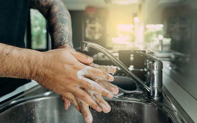 A man washing his hands with foam hand wahs for corona virus prevention, hygiene to stop spreading coronavirus.