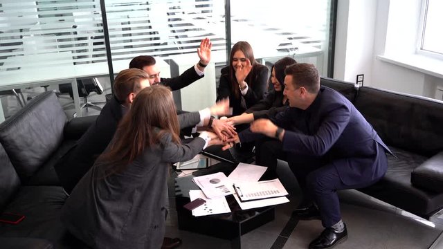 a group of happy colleagues join forces. Creative team