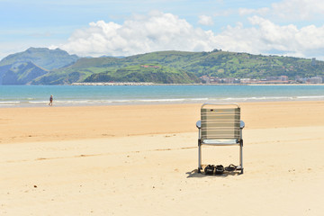 Lonely beach chair on an empty beach
