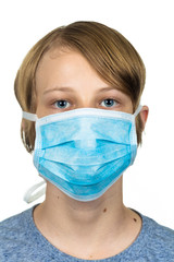 Young teenage boy wearing a protective mask. Isolated on white.