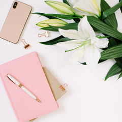 Beautiful fresh white lily and notebook with blank page on white background. Mood blogging concept, Square picture