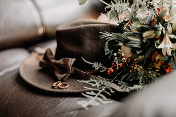 men's wedding preparations. Elements of clothing, wedding rings, bouquet on a stone floor with place for your text