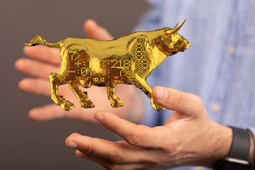 Bull shapes that look like made of origami paper with symbols of stock market trends on them....