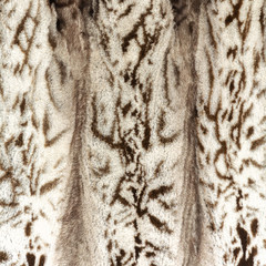 Natural beige brown shiny fur texture with large spots and beautiful folds