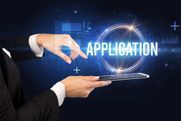 Close-up of a touchscreen with APPLICATION inscription, new technology concept