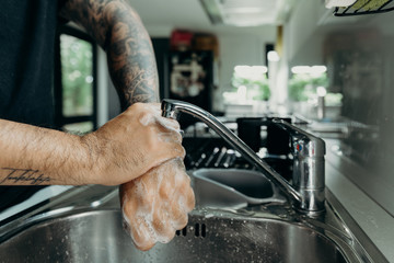 A man washing his hands with foam hand wahs for corona virus prevention, hygiene to stop spreading coronavirus.
