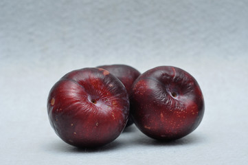 Ripe plums on a white background
