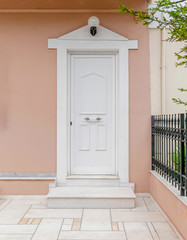 house entrance white door and dark pink wall