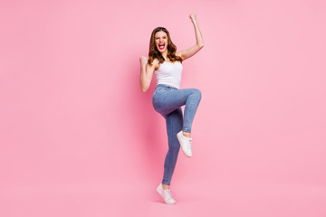 Full length photo of delighted cheerful girl enjoy her sport competition victory raise fists scream yeah wear good look modern clothing isolated over pastel color background