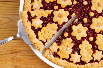 Closeup homemade cherry pie crostata on wooden table. Top view.