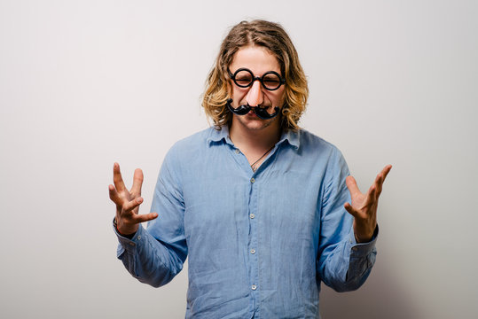 a man of a fake nose and glasses, with mustache and furry eyebrows