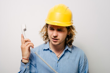 Young contractor on the phone in the office. Construction