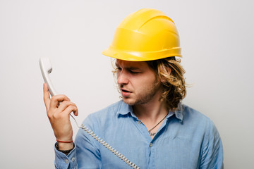 Young contractor on the phone in the office. Construction