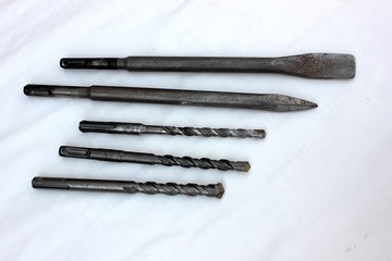 Drills for the puncher isolated on white. Old steel drills with a diameter of 8, 10 and 12 mm....