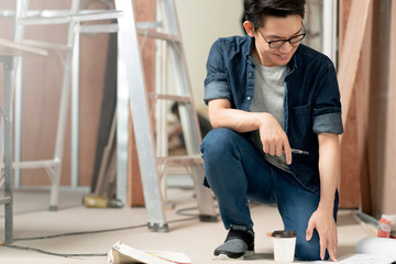 smart attractive glasses male casual costume contractor woodwork on site home renovation concept smile and confident carpenter contractor at site construction background © whyframeshot