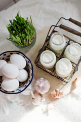 Fototapeta na wymiar Eco farm products. Fresh eggs, milk and garlic