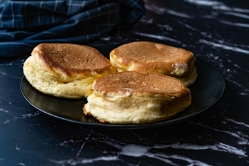 Homemade Plain Fluffy Souffle Pancake in Black Plate Ready to Eat.