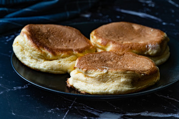 Homemade Plain Fluffy Souffle Pancake in Black Plate Ready to Eat.