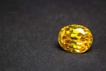 Natural yellow Sapphire gemstone, beautiful yellow gold citrin gemstone isolated on black background, as jewelry background