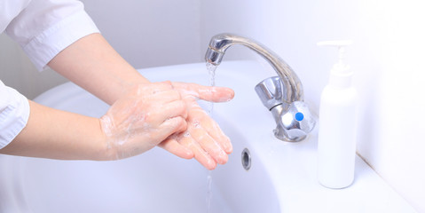 A female doctor washes her hands thoroughly.  Pandemic virus COVID-19