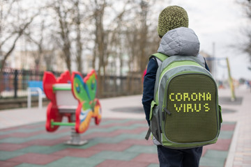 A school boy in front of the empty playground during coronavirus quarantine.