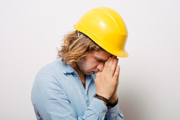 Construction worker praying