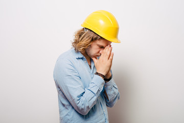 Construction worker praying