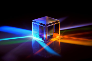 a glass cube reflects many colors